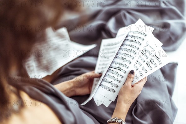 Close up music notes in women's hands