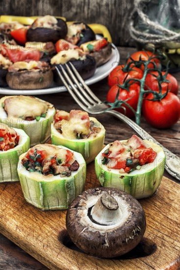 Easy appetiser of courgette stuffed with cheese, garlic and tomatoes.Photo tinted.Selective focus