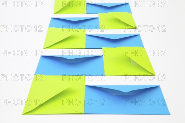 Composition with green and blue envelopes on the white table