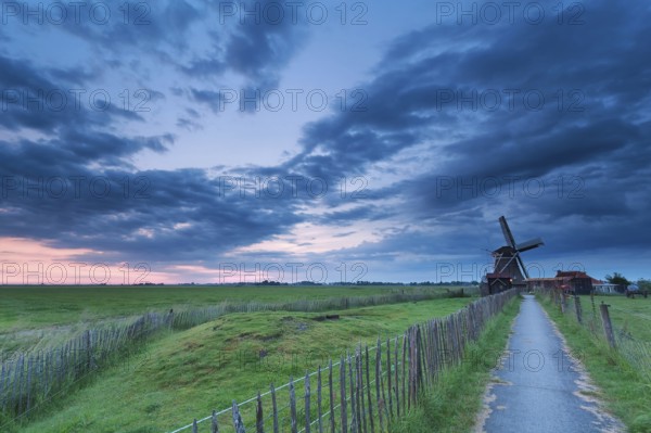 Path to windmill in clouded dusk, Groningen, Netherlands