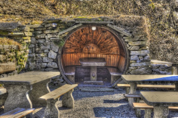 Rustic Restaurant with Tables and Benches Made in Stone and Wood in Circle Shape in a Sunny Day in Ticino, Switzerland, Europe