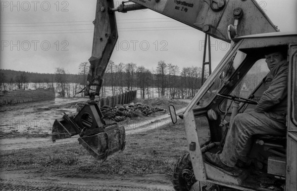 Germany, Sternberg, 12.01.1992, excavator driver, empty silo, old tyres, near Sternberg / Mecklenburg, Europe