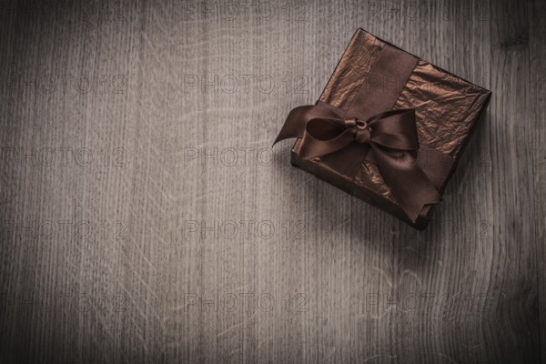 Present boxed in glittery crumpled paper with bow celebration concept