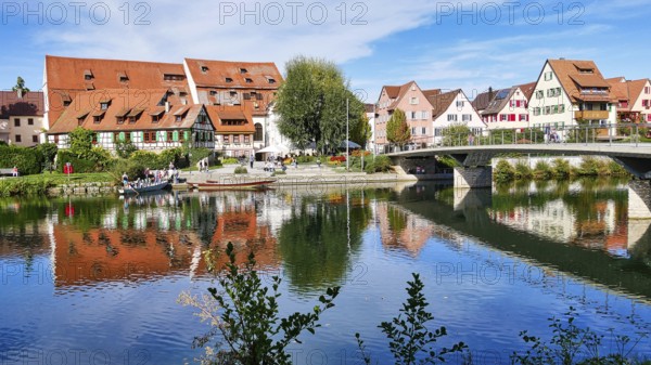 View of the riverside promenade in Rottenburg am Neckar with a punt