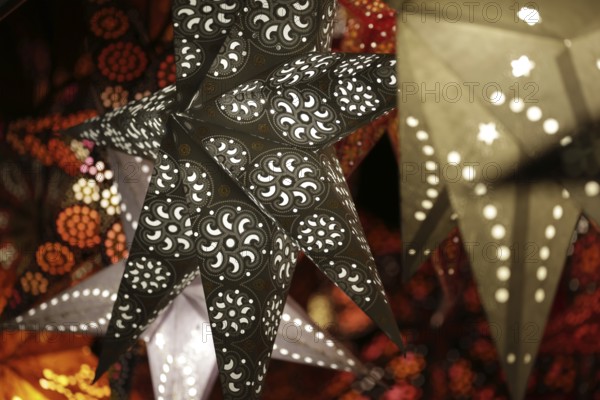Decorative, illuminated stars with an artistic pattern create a warm, Christmassy atmosphere at a Christmas market, Cologne, North Rhine-Westphalia, Germany, Europe