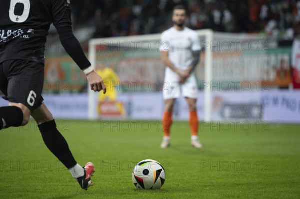 LUBIN, POLAND - MARCH 1, 2025: Football match between KGHM Zaglebie Lubin vs Piast Gliwice. One player kicks the ball opponent player in the wall