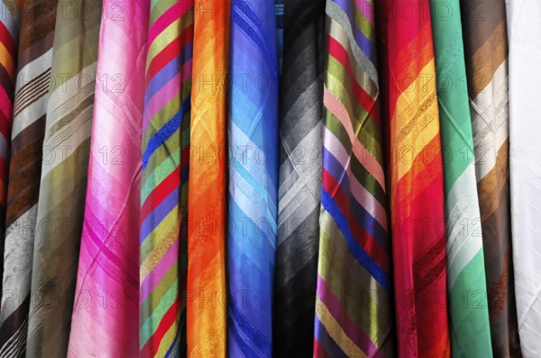 Fez, Hanging colourful textiles show a variety of patterns and materials, Northern Morocco, Morocco, Africa
