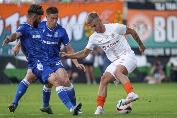 LUBIN, POLAND - AUGUST 17, 2024: Football match Polish PKO Ekstraklasa between KGHM Zaglebie Lubin vs Lech Poznan. Ali Gholizadeh (L) Radoslaw Murawski (M) Marek Mroz (R).