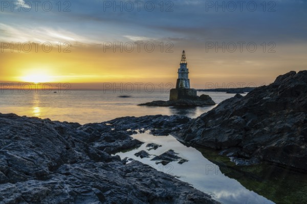 The Athopol Lighthouse on the Black Sea coast of Bulgaria with tidal pools in the foreground at sunrise