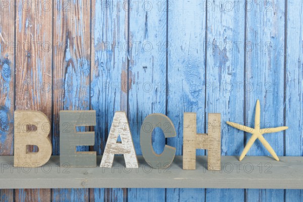 Blue wooden background with beach text