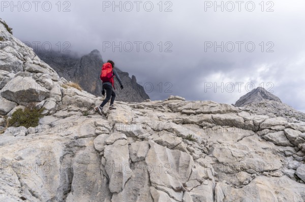 Hiker on the crest of Puig de Ses Vinyes, 1105 meters, sierra de tramuntana, Escorca, Majorca, Balearic Islands, Spain, Europe