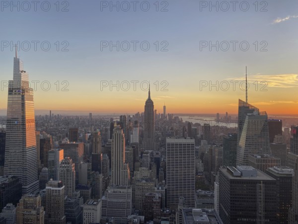 Panorama of New York at sunset with the Empire State Building in the centre, the skyline of a big city with skyscrapers in the golden light of the sunset, new york, USA, North America