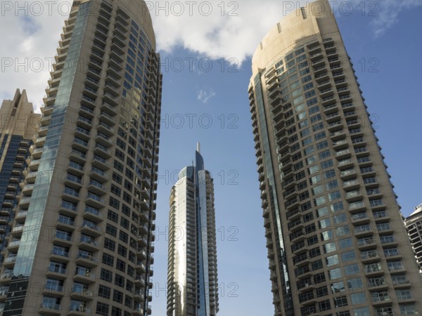 Three modern skyscrapers with glass facades under a bright blue sky, modern skyline with imposing skyscrapers and glass facades, Dubai, United Arab Emirates, Asia
