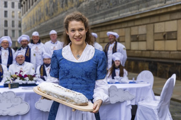 To mark the official start of the stollen season, the Dresden stollen girl Lorna Prenzel and the Dresden stollen bakers brought a large table to the Fürstenzug and thus a special place in the centre of Dresden's old town, Press event Stollen girls, Dresden, Saxony, Germany, Europe
