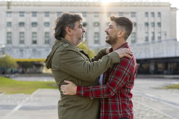 Two married men who are in love are embracing each other