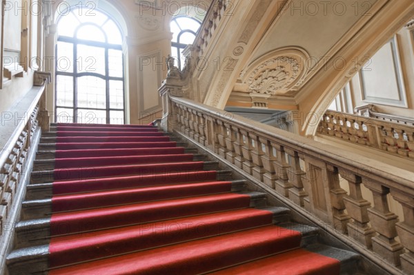 Turin, Italy, January 2023: Palazzo Barolo staircase. Luxury palace with old baroque interior and red carpet, Europe