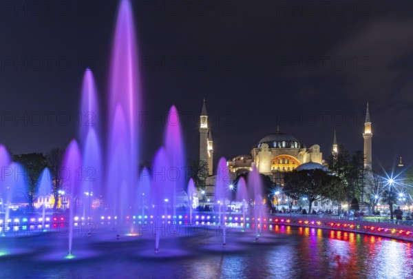 A picture of the Hagia Sophia and the colorful Sultan Ahmet Park Fountain at night