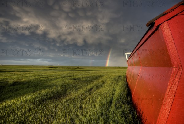 Abandoned Farm with storm clouds in the Canadian Prairie