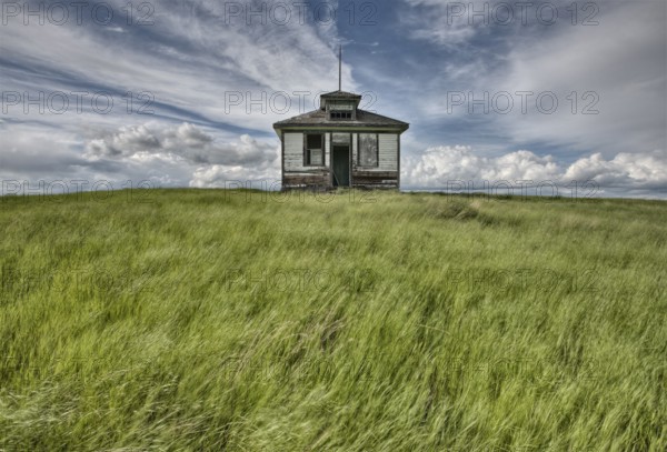 Abandoned Farm with storm clouds in the Canadian Prairie