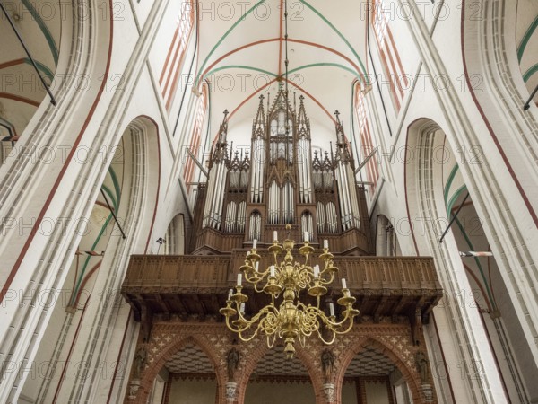 Interior view of a church with a large organ and a chandelier, Gothic architecture, Schwerin, Meckelnburg-Vorpommern, Germany, Europe