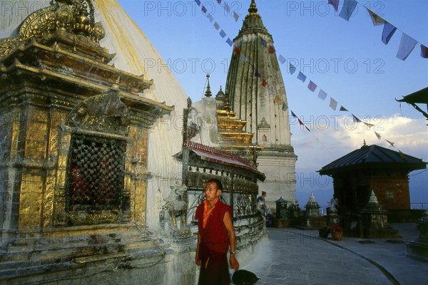 The date of construction of the Svayambhunath stupa, its origins steeped in myth, is unknown. According to the inscriptions on an ancient and damaged stone tablet at Svayambhunath, King Vrishadeva (ca. 400 CE) was the first to build a place of worship on the site. His grandson, King Manadeva I (ca. 464-505) may have made some additions.<br/><br/> The Muslim invasion of 1349 undid all the pious building work, the marauding Muslim warriors dismantling every kafir (infidel) sanctuary that they came across. An inscription at Svayambhunath records the date of the Muslim invasion as 20 November 1349, in all probability a very accurate account. After the raids Svayambhunath was restored, and most of the buildings seen today are from the post-invasion period.<br/><br/> Swayambhunath (Devnagari: ??????????? ?????) is an ancient religious complex atop a hill in the Kathmandu Valley, west of Kathmandu city. It is also known as the Monkey Temple as there are holy monkeys living in parts of the tem...