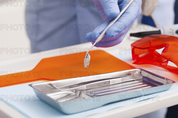 Dental instruments for test the oral cavity and doctor', s hand close up
