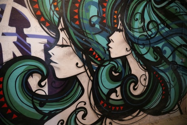 MAUSA VAUBAN, Museum of Urban Art and Street Art, Neuf-Brisach Fortress, France, Europe, Mural with abstract woman's heads painted in black, green, red and orange, Europe