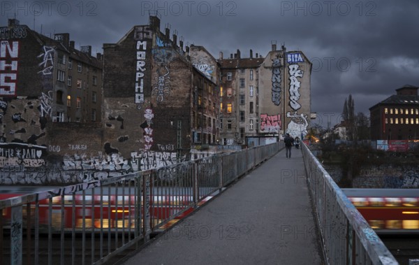 Germany, Berlin, 17.12.2024, View from Schönfließer Brücke, rear building gable Kopenhagener Straße, regional train, Europe