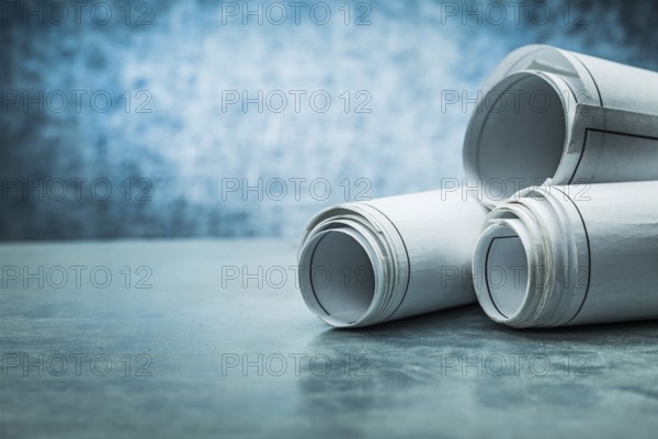 Close up view on roled blueprint metalic background