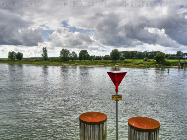 Vast river landscape under a dramatic sky, calm water and nature, zutphen, gelderland, achterhoek, the netherlands