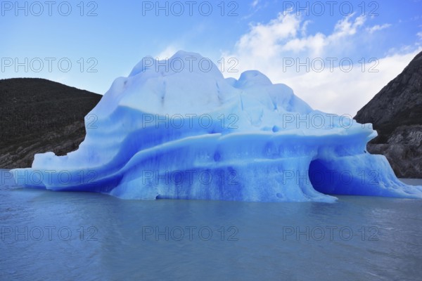 Journey to the End of the World. Chilean Patagonia in the sunlight. Blue Ice Glacier Gray is reflected in the lake