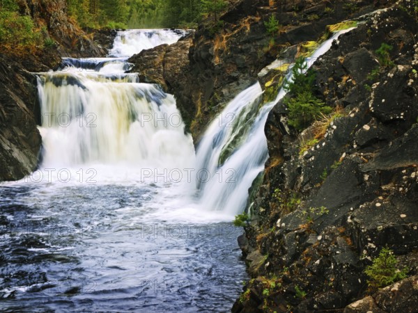 Nature waterfall in dark rocks