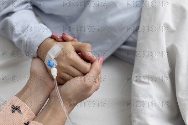 A deeply touching moment of support and emotional connection shared in the comforting atmosphere of a hospital setting