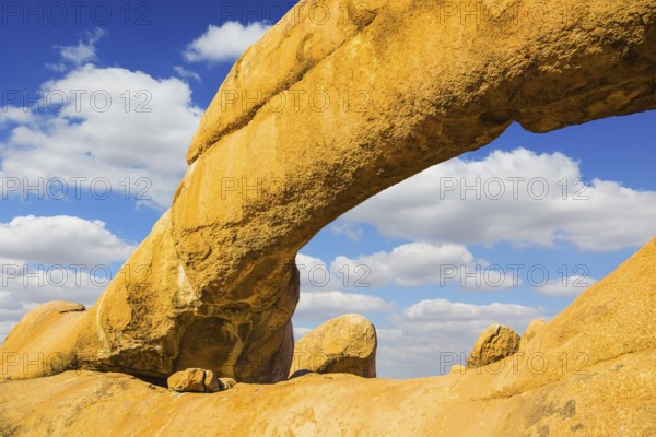 The natural massif of smooth bald granites among the Namib Desert. Stone arch of Spitzkoppe, Namibia. Concept of extreme and ecological tourism