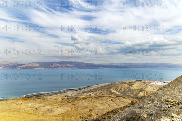 The great wonder of nature is the Dead Sea. The sea surface reflects the clouds. Israeli coast. Cloudy and clear January day