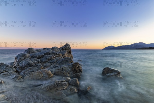 Rocks in the sea on the beach of Torre di Bari at sunset, long exposure, Torre di Bari, Bari Sardo, Ogliastra, Sardinia, Italy, Europe