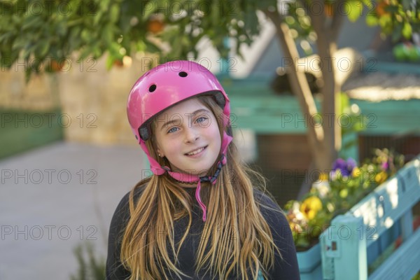 Blonk kid skate girl helmet portrait outdoor smiling
