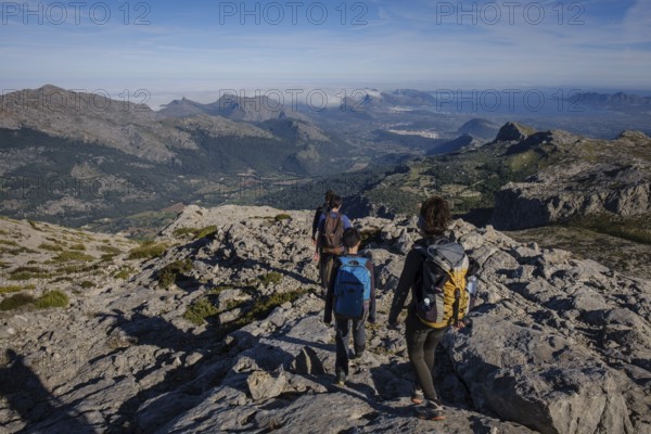 Hikers descending the Puig Tomir towards Fartaritx, Majorca, Balearic Islands, Spain, Europe