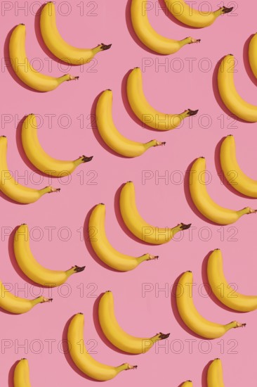 Food design. Pattern composition of a pair of bananas lying next to a pink background. Mock up, top view, flat lay style