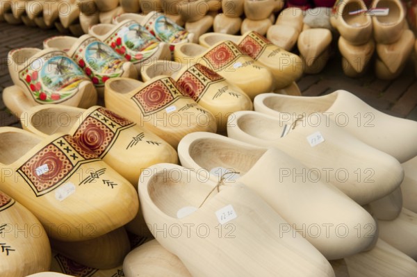 Many different Dutch wooden clogs at the market in Holland