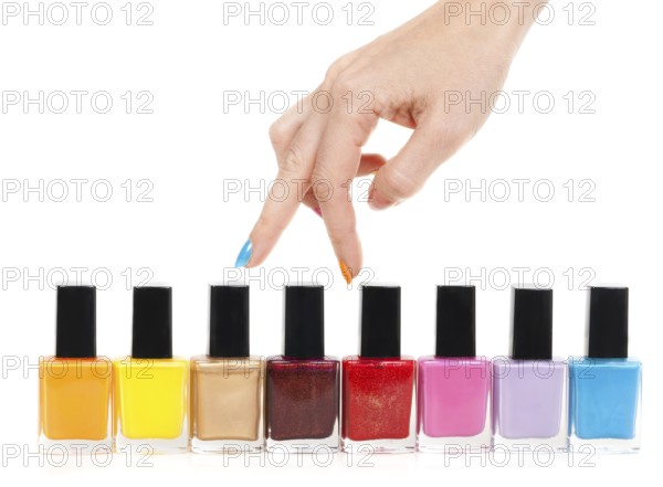 Female hand fingers are the colored paints polish on a white background
