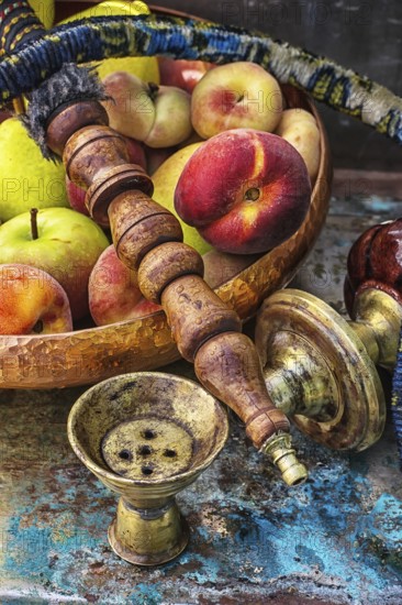 Details were worked hookah on the table amid fresh peaches.Photo tinted
