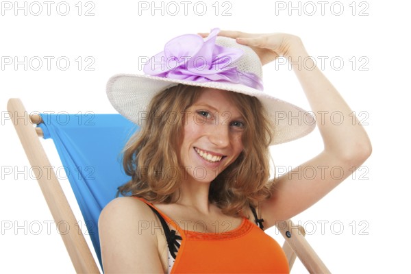 Blue beach chair with young woman for sun bath