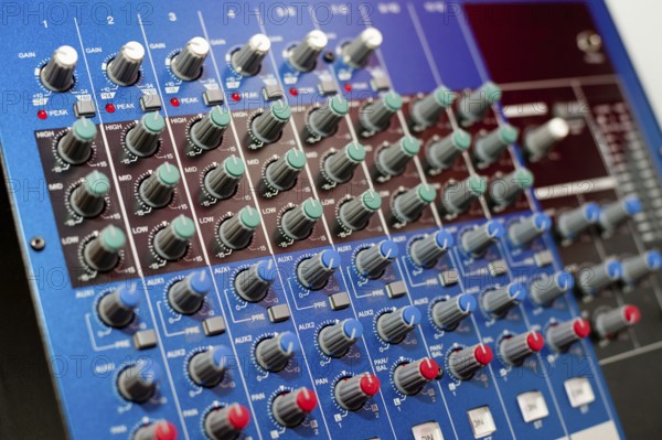 An audio control console, closeup, narrow focus