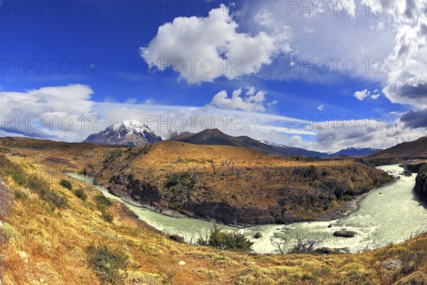 Travel to Chile. The river bends a horseshoe under the flying clouds. The picture was taken Fisheye lens