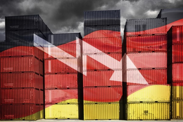 Stacked containers in German national colours with downward pointing arrow, symbolic photo economic crisis, photomontage