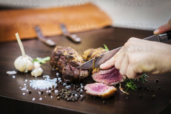 Serving carving roast pork meat roll meal in rustic style with seasonings