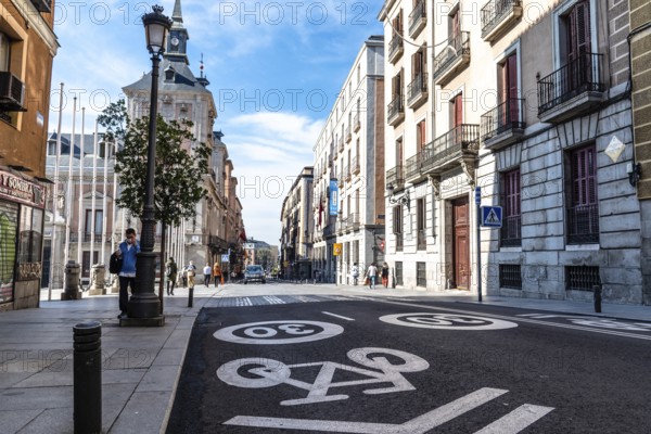Madrid, Spain, November 1, 2020: Mixed traffic lane for bicycles and cars with a maximum limit of 30 kilometers per hour painted on the asphalt. Central Madrid. Mayor Street, Europe