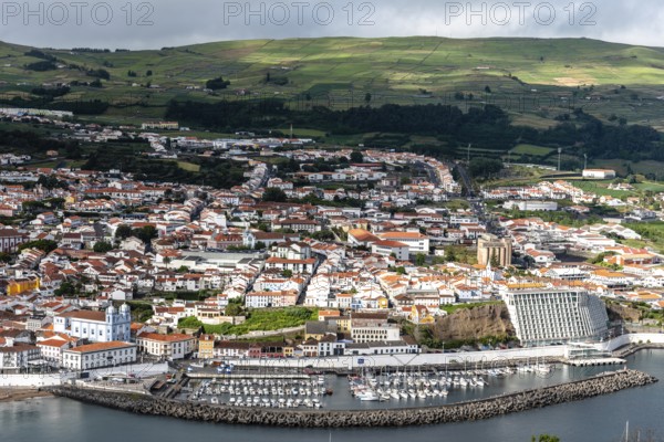 Angra do Heroismo, Portugal, July 1, 2022: Panoramic Aerial View of the old Town and the port of Angra do Heroismo from Monte Brasil, Terceira Island, Portugal, Europe