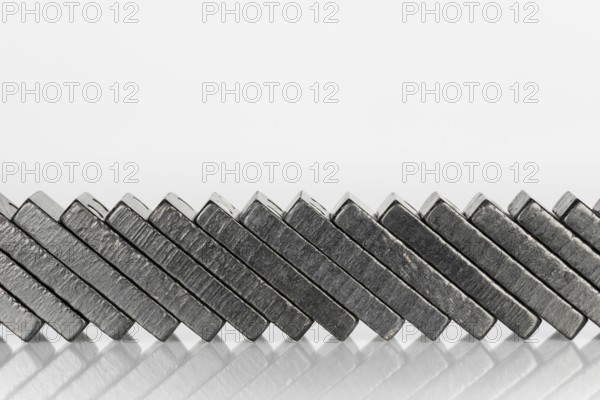 Composition of lying black domino bricks with white dots